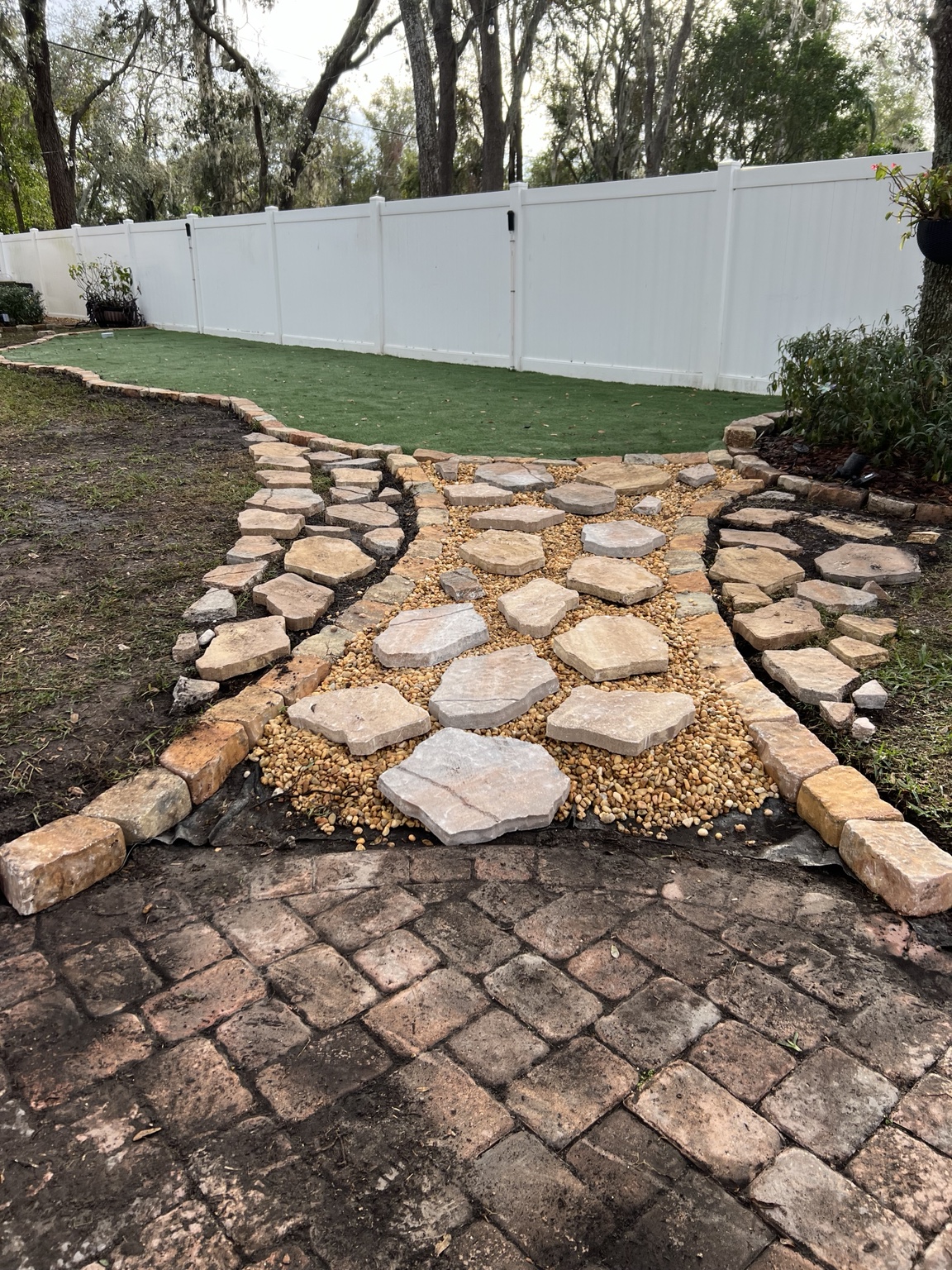 Stone path and curved edging before the surrounding turf is installed