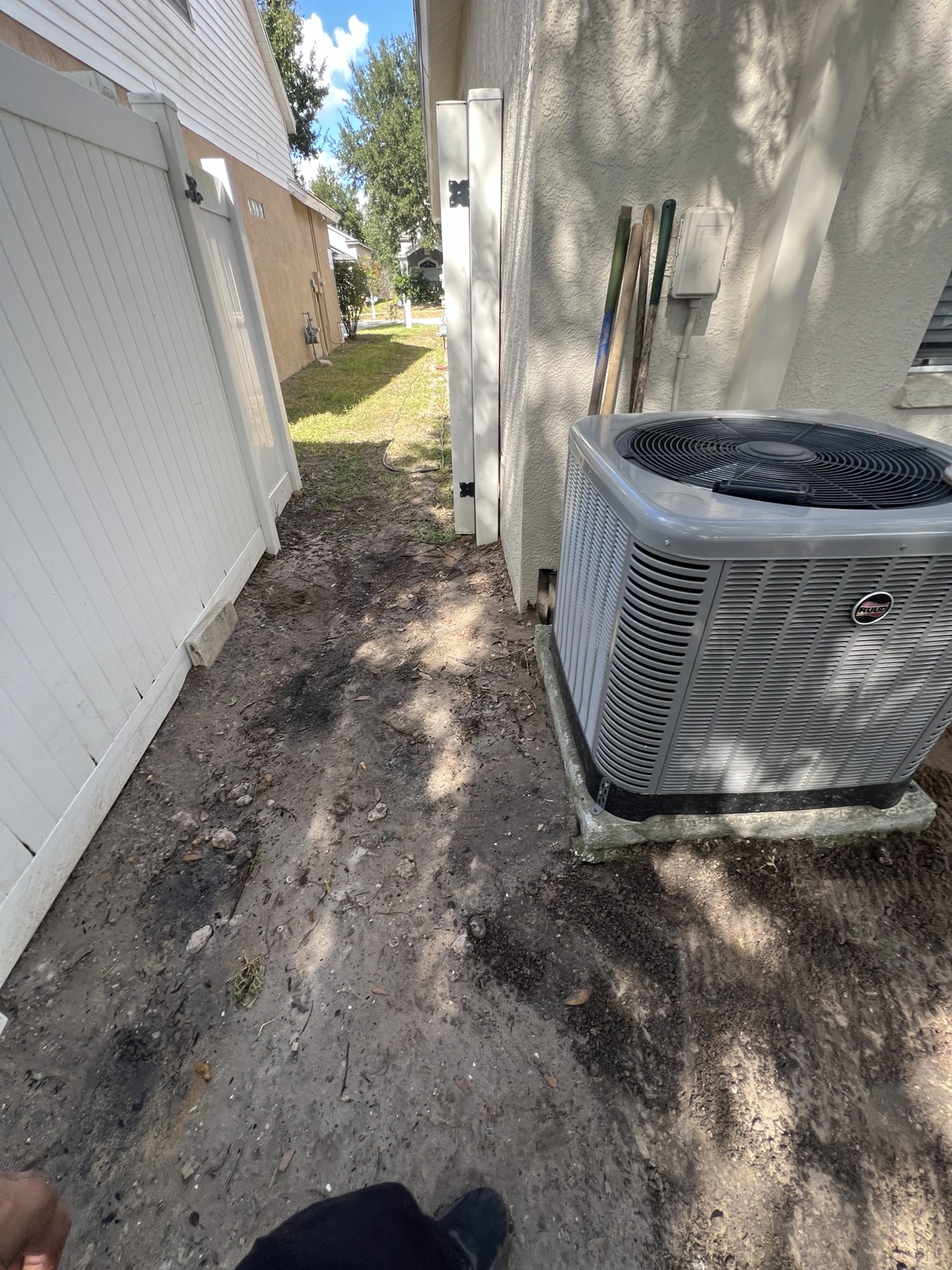 Narrow side yard beside the house during site preparation