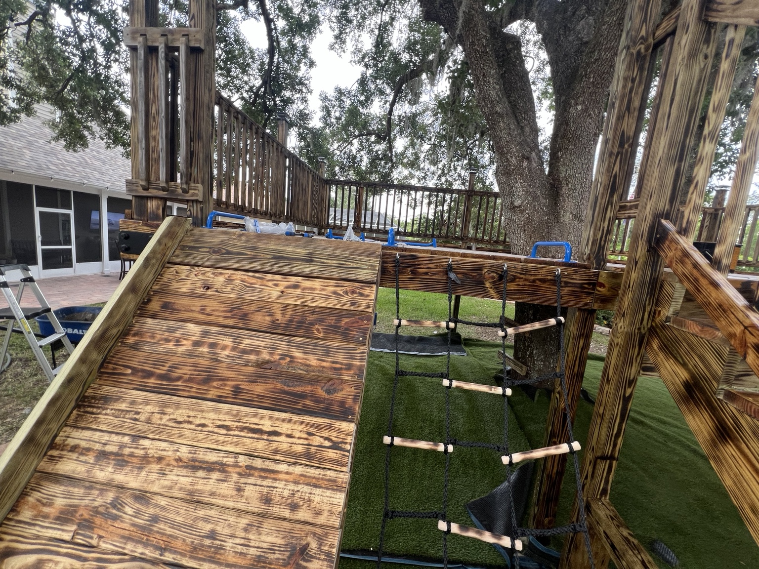 Wood play structure and artificial turf during installation